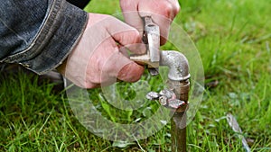 Man Fixing Garden Water Pipe