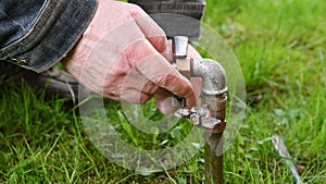 Man Fixing Garden Water Pipe