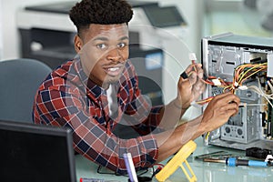 man fixing pc while looking at camera