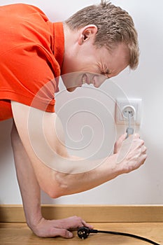 Man fixing socket being electrocuted