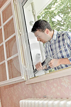 man fixing window