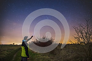 Man with flashlight observing night sky