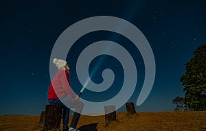 Man with flashlight among Stary Night at view point of Doi Samer Dow