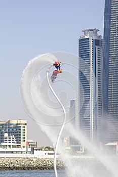 Man on flayborde doing flip jump in international competitions in extreme water sports