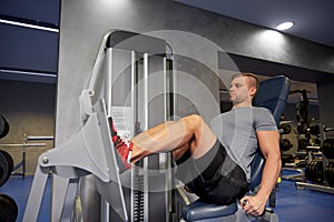 Man flexing leg muscles on gym machine