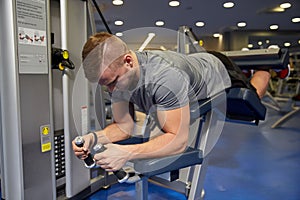 Man flexing leg muscles on gym machine