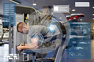 Man flexing leg muscles on gym machine