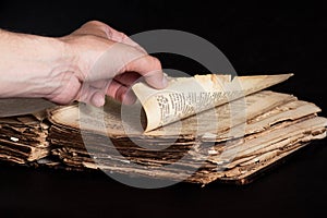 Man flips through an old copy of the Bible