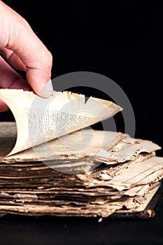 Man flips through an old copy of the Bible