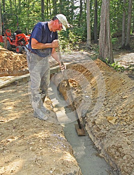 Man floating concrete footer