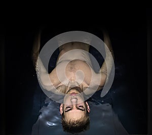 Man Floating In A Sensory Deprivation Isolation Tank