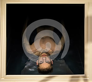 Man Floating In A Sensory Deprivation Isolation Tank