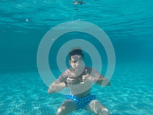 A Man floating under water in the pool