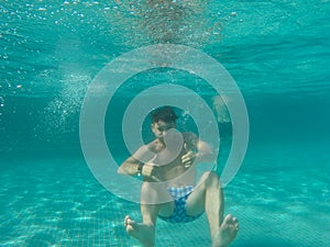 A Man floating under water in the pool