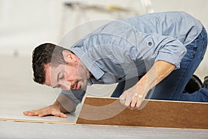 Man during flooring installation