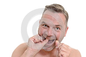 Man flossing his teeth with dental floss