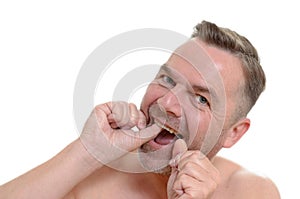 Man flossing his teeth with dental floss