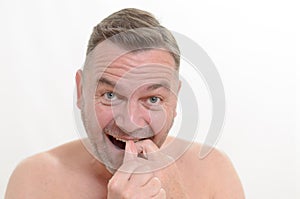 Man flossing his teeth with dental floss