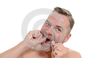 Man flossing his teeth with dental floss