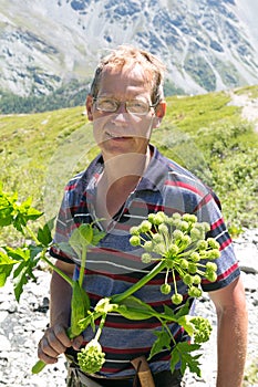A man with a flower kurai in the mountains of Siberia Altai.