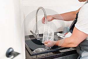 A man flushes the air cleaner filter from the air conditioner. photo