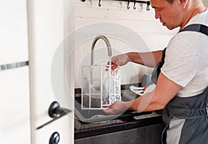 A man flushes the air cleaner filter from the air conditioner. photo