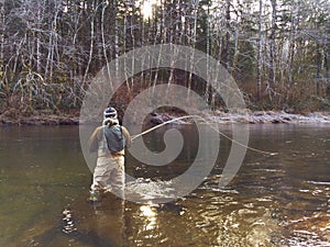 Man Fly Fishing in Cold Winter Weather