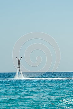 Man on flyboard above the clear sea. Water extreme sports