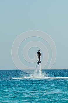 Man on flyboard above the clear sea. Water extreme sports