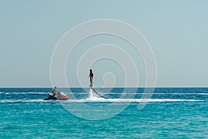 Man on flyboard above the clear sea. Water extreme sports