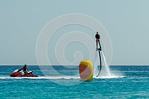 Man on flyboard above the clear sea. Water extreme sports