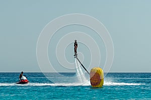 Man on flyboard above the clear sea. Water extreme sports