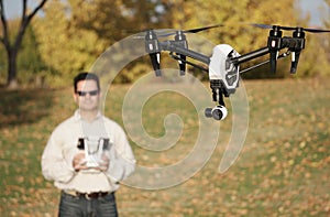Man Flying A High-Tech Camera Drone (Fall Trees & Leaves in Background)
