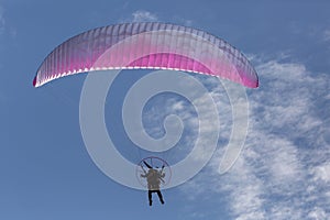 Man flying motorized parasail away from the camera