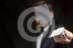 Man with flying playing cards