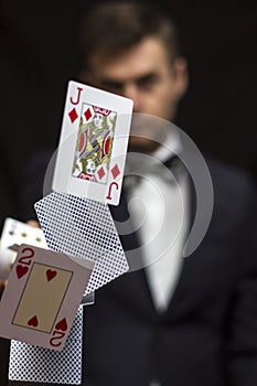 Man with flying playing cards