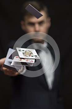 Man with flying playing cards