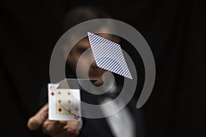 Man with flying playing cards