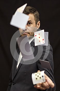 Man with flying playing cards