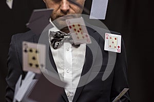 Man with flying playing cards