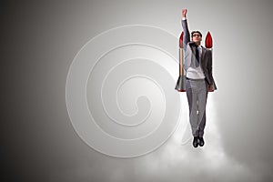 The man flying with the rocket in business concept