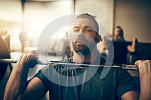 Man focused on his lift during a gym weight session