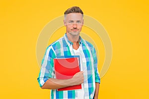 Man with folder yellow background. Businessman hold book for notes. guy has notepad for writing. handsome school or