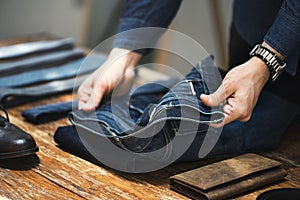 Man folding jeans concep clothing