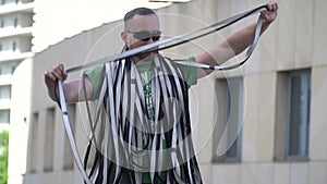 A man folds slings for slackline while another man treats him with chocolate