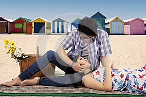 Man fondle his girlfriend at beach photo