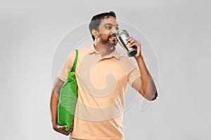 Man with food in bag and tumbler or thermo cup