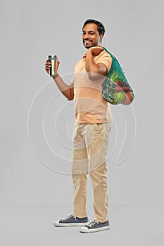 Man with food in bag and tumbler or thermo cup