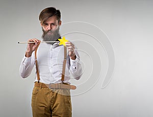 A man fooling around with a children`s magic wand