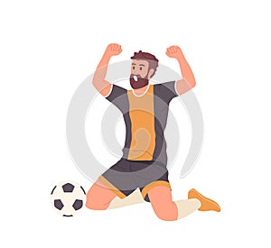 Man football player sitting on floor with raised hands up screaming celebrating goal score